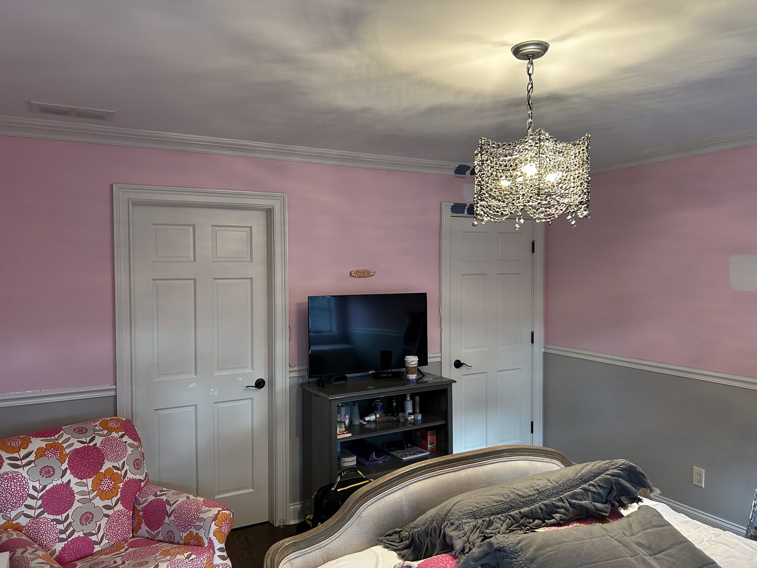 Bedroom with white doors and pink walls before repaint