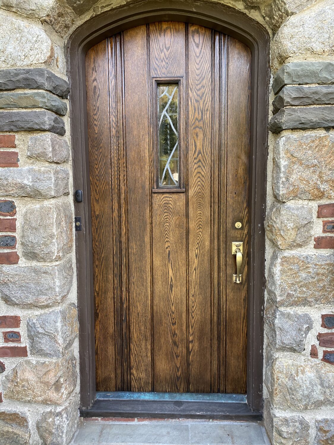 Arched front door stripped and re-stained rich brown