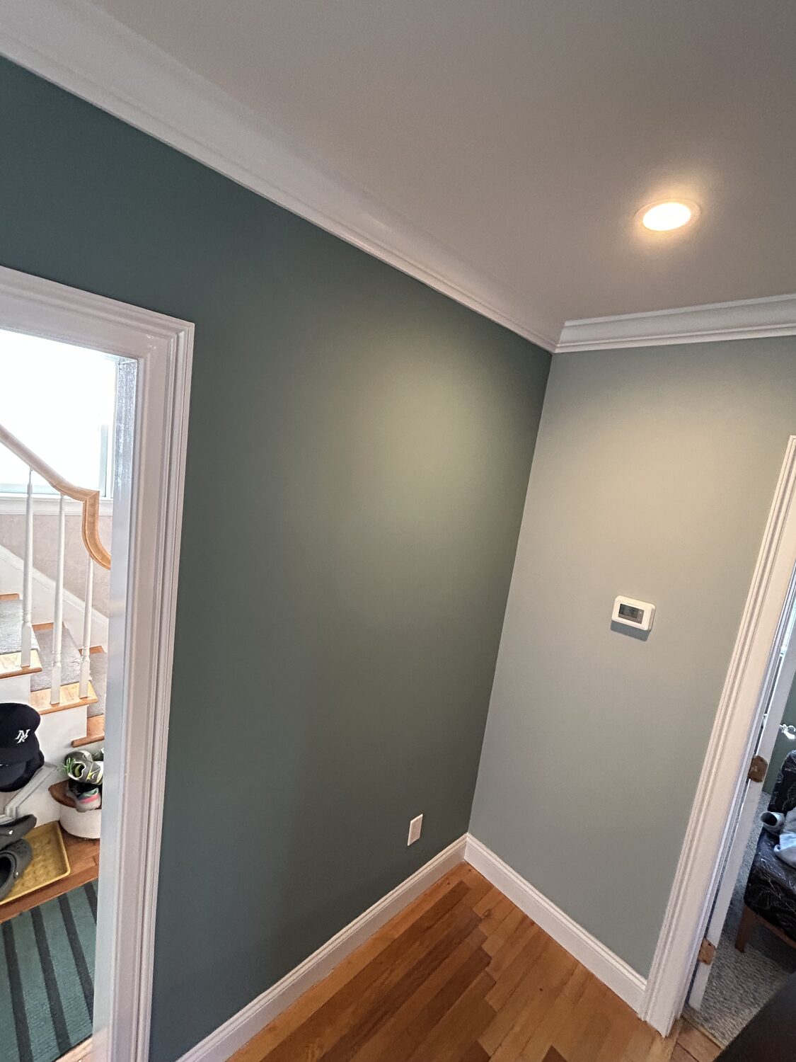 Stairwell finished in deep teal with white trim